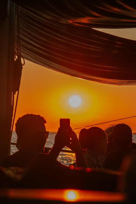 Argostoli: Sunset Cruise with Swim Stops, Dinner, and Wine - Xi Beach and the red-brick-colored shore