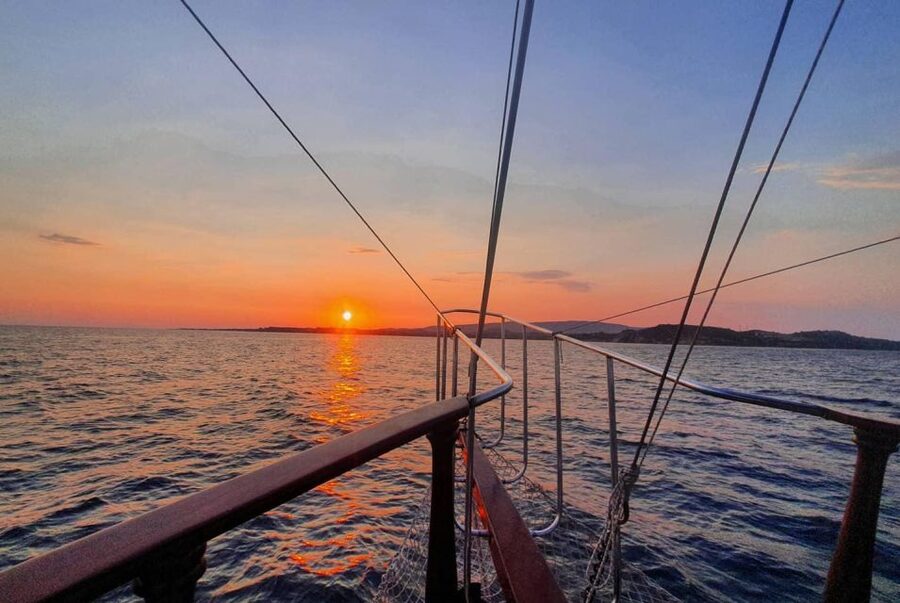 Argostoli: Sunset Cruise with Swim Stops, Dinner, and Wine - Sunset and the return under the stars