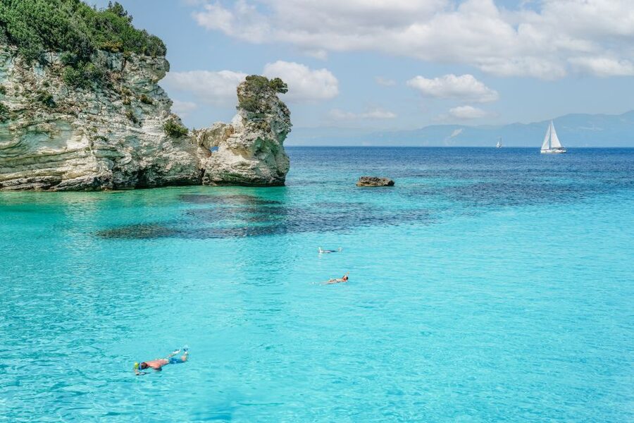 From Corfu Island: Antipaxos & Paxos Blue Caves Boat Cruise - Entering the Blue Caves along Paxos’s west coast