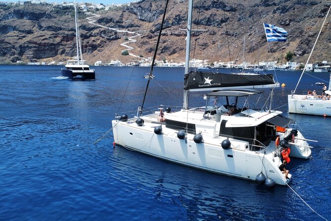 Half Day Premium Catamaran Cruise in Santorini including Oia - Starting with Red Beach and its volcanic colors