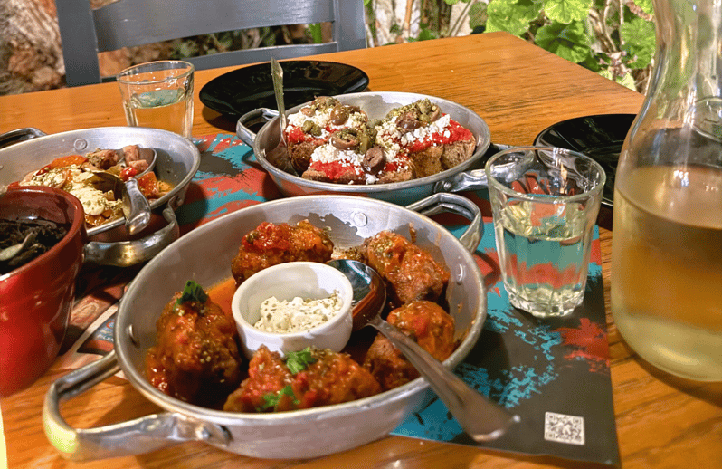 Rethymno Old Town: A Traditional Cretan Food Tour - First stop: raki and three Cretan dishes