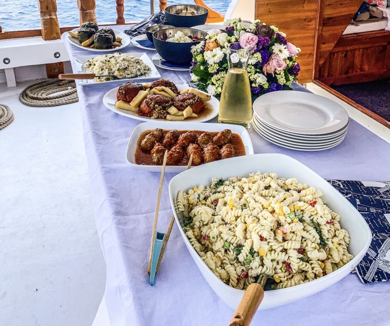Rhodes: Cruise with 3 Stops, Lunch and Unlimited Drinks - Leaving Mandraki Port on a classic wooden boat