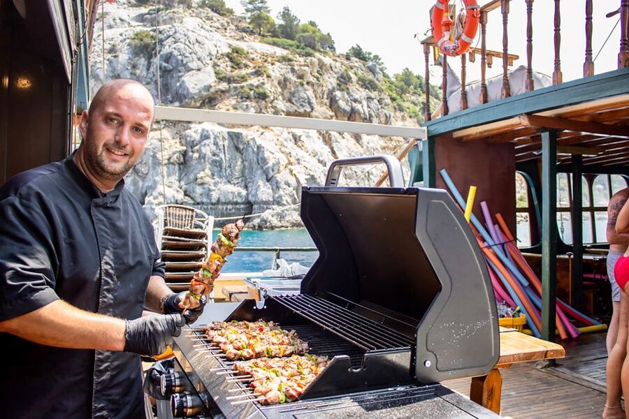 Rhodes: Sunset Cruise with Greek BBQ and Unlimited Drinks - Watching the sun drop behind Rhodes