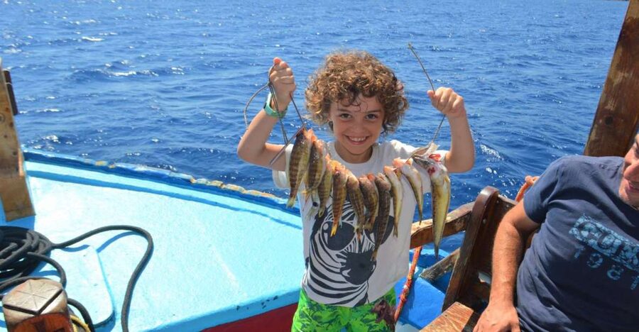 Rhodes Town: Fishing Boat Trip with Fish Meal and Swim Stops - Learning to fish with Angelo
