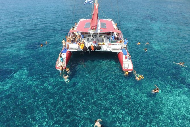 Sailing Catamaran Cruise in Santorini with BBQ, Drinks and Transfer - Red Beach from the water