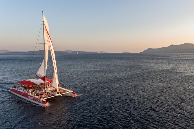 Sailing Catamaran Cruise in Santorini with BBQ, Drinks and Transfer - Sailing past Santorini’s volcanoes