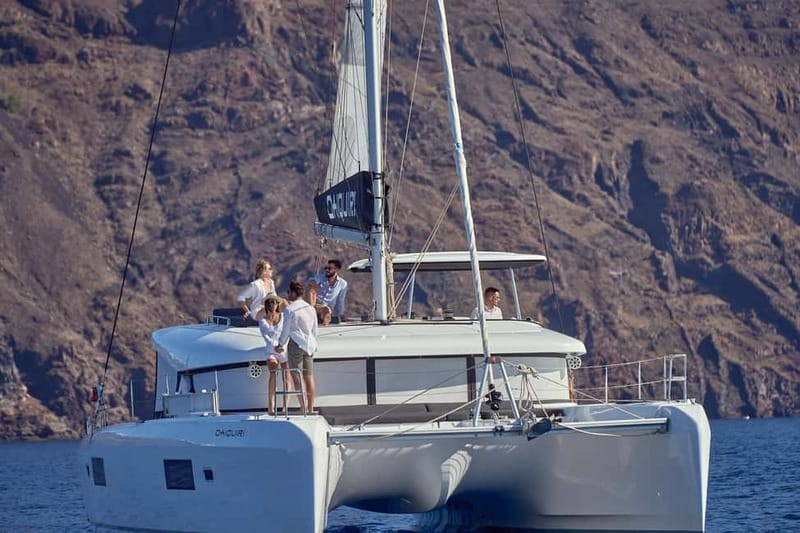 Santorini: Caldera Classic Catamaran Cruise w/ Meal & Drinks - Akrotiri Lighthouse and the volcanic coast
