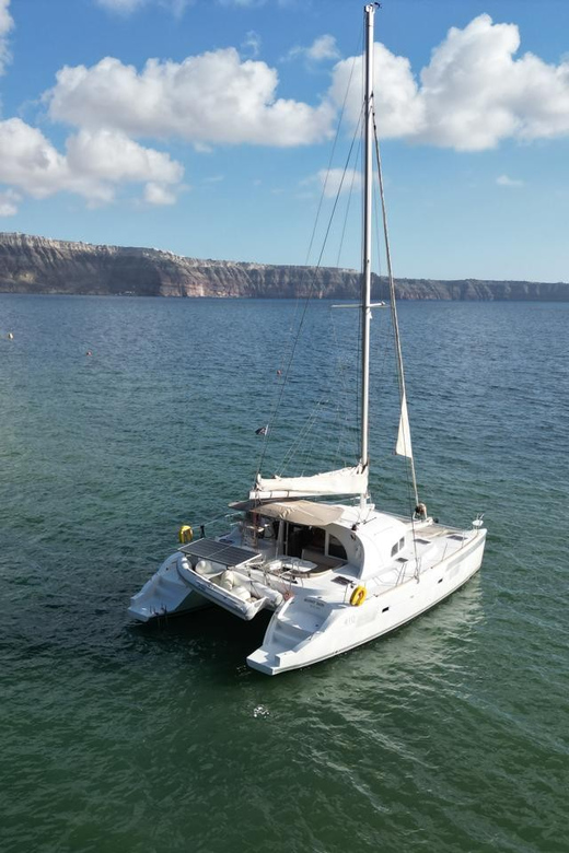 Santorini: Catamaran Cruise with Greek BBQ and Drinks - White Beach and the sea caves