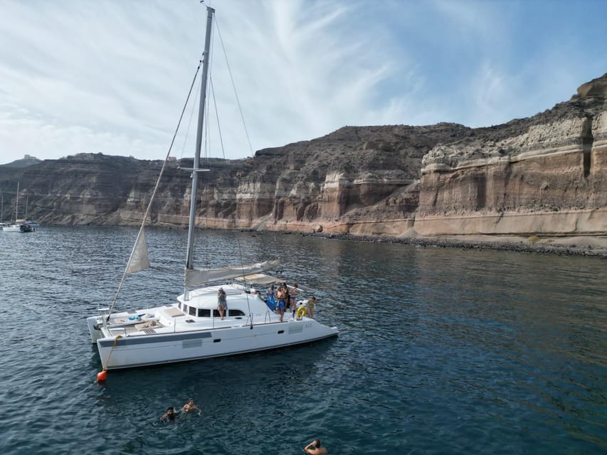 Santorini: Catamaran Cruise with Greek BBQ and Drinks - Indian Rocks and the Venetian Lighthouse