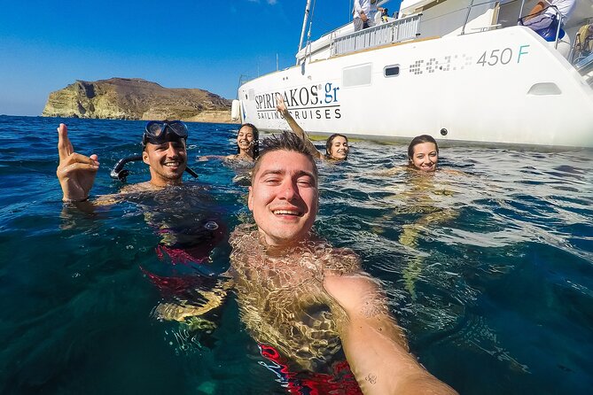 Santorini Classic Catamaran Cruise with BBQ, Drinks and Transfers - Indian Rocks, caves, and the caldera edge