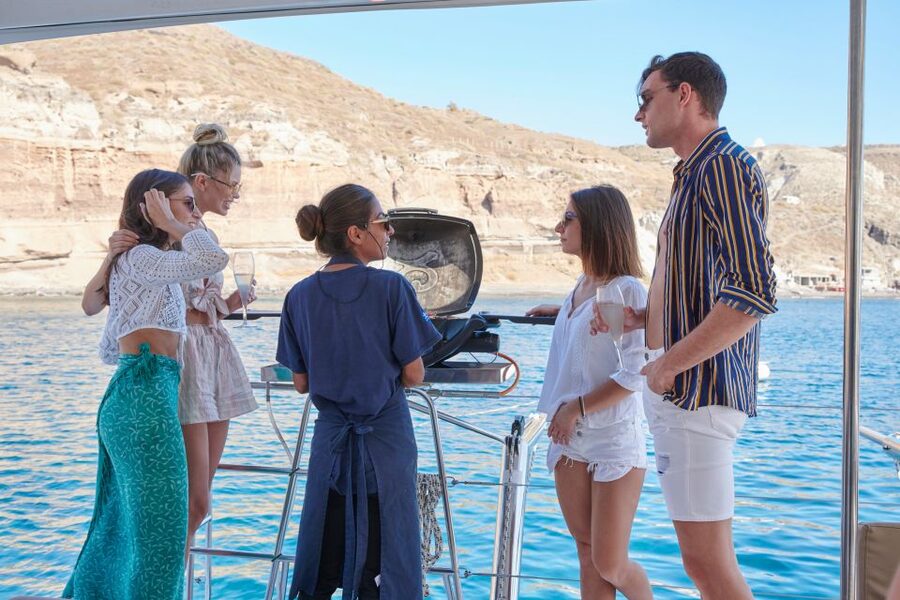 Santorini Gold Catamaran Cruise with Snorkel, BBQ & Open Bar - A sea-level view of the caldera cliffs