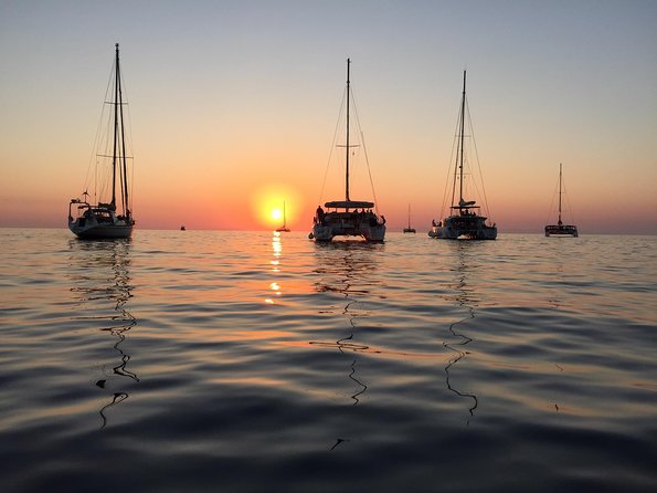 Santorini Luxury Catamaran Sunset Cruise with BBQ, Drink and Transfer - Red Beach, swimming, and snorkeling