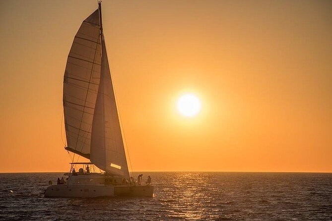 Santorini Private Catamaran Cruise with BBQ, Open Bar & Transfers - Red Beach and the Iron-Colored Cliffs