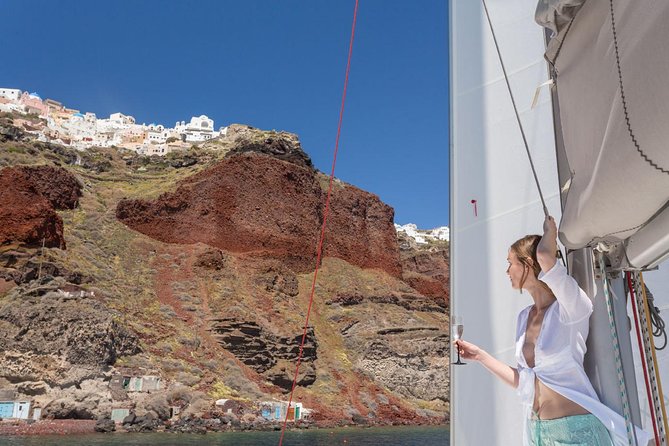 Santorini Private Catamaran Cruise with BBQ, Open Bar & Transfers - Indian Rocks, the Lighthouse, and the Caldera View