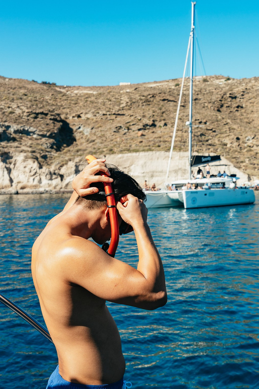 Santorini: Private Catamaran Tour with BBQ Meal and Drinks - Red Beach and the strange colors of Santorini